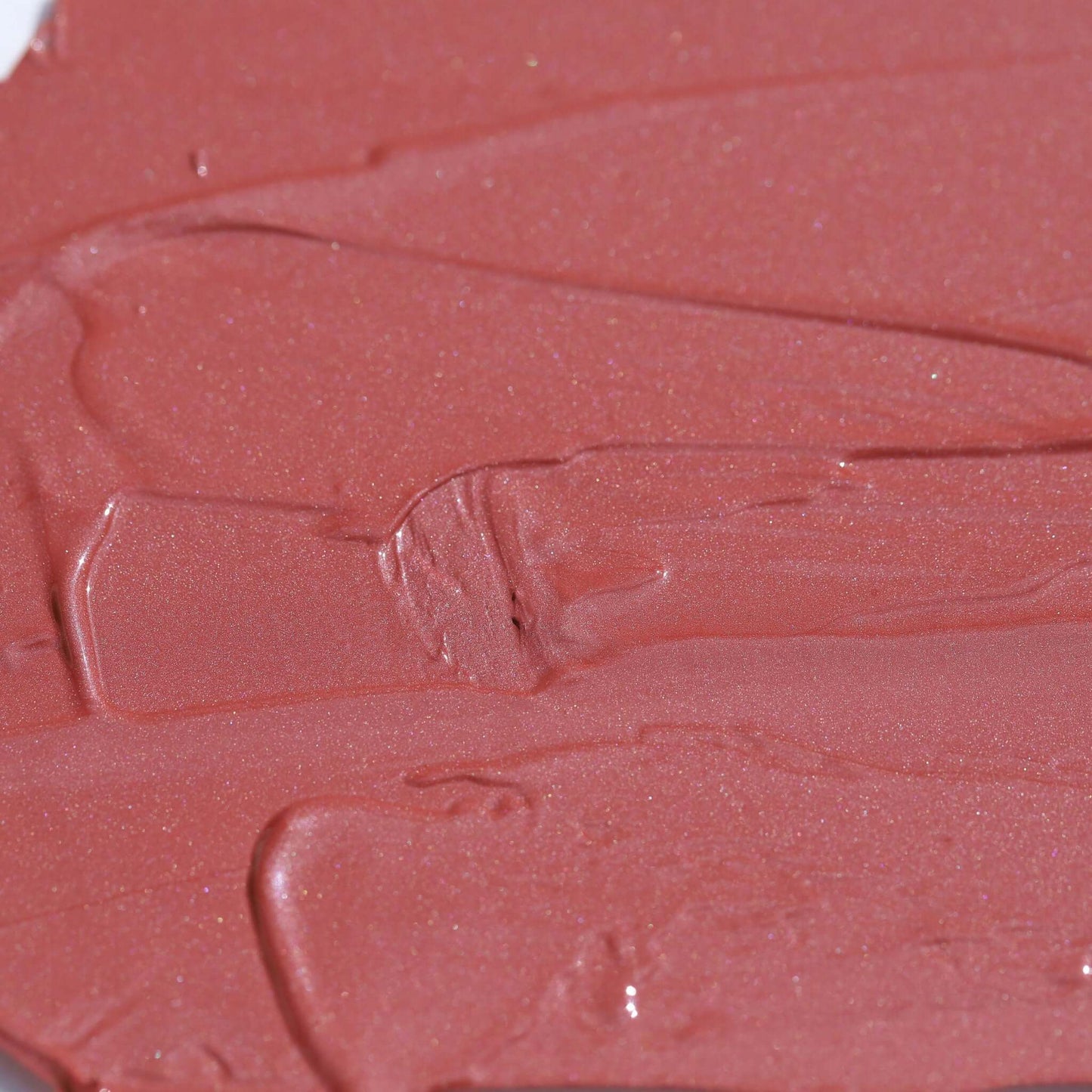 Close-up texture of Candy Paint Cheek + Lip Tint in soft mauve shade, showcasing dewy finish and creamy consistency perfect for radiant skin.