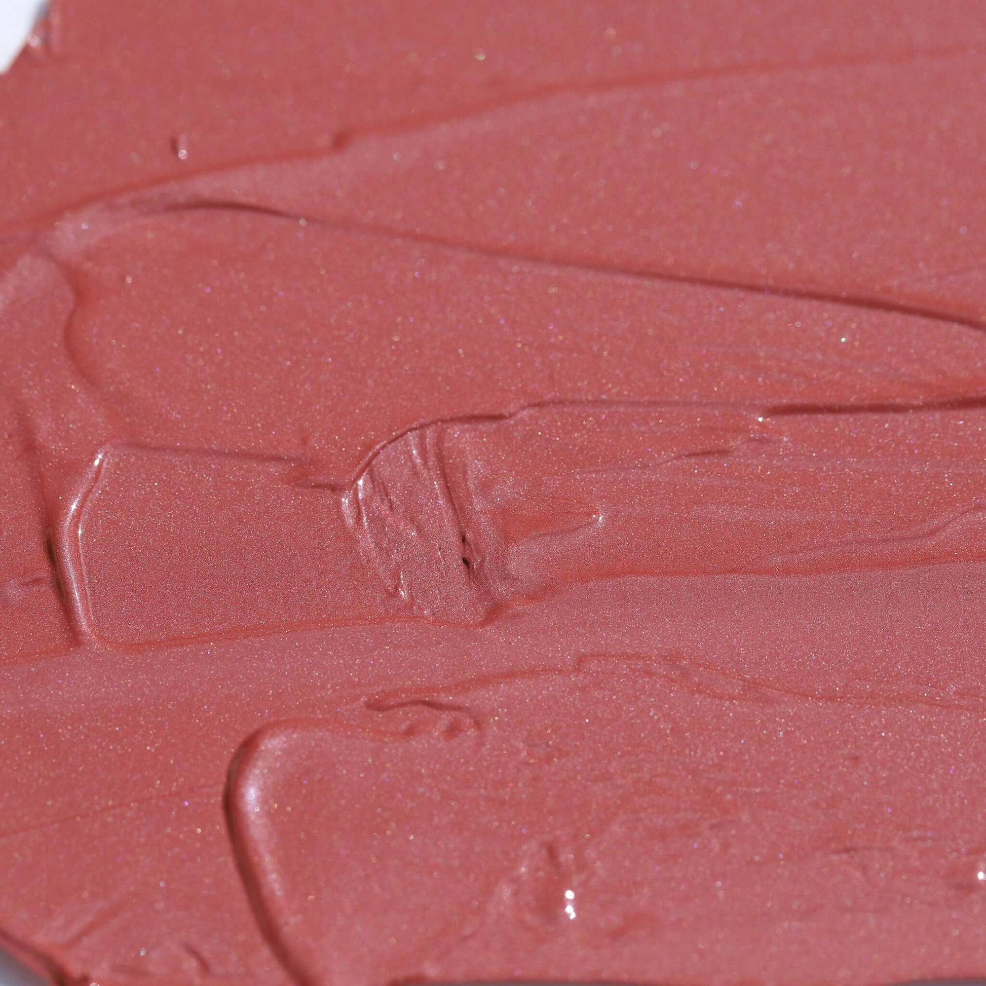 Close-up texture of Candy Paint Cheek + Lip Tint in soft mauve shade, showcasing dewy finish and creamy consistency perfect for radiant skin.