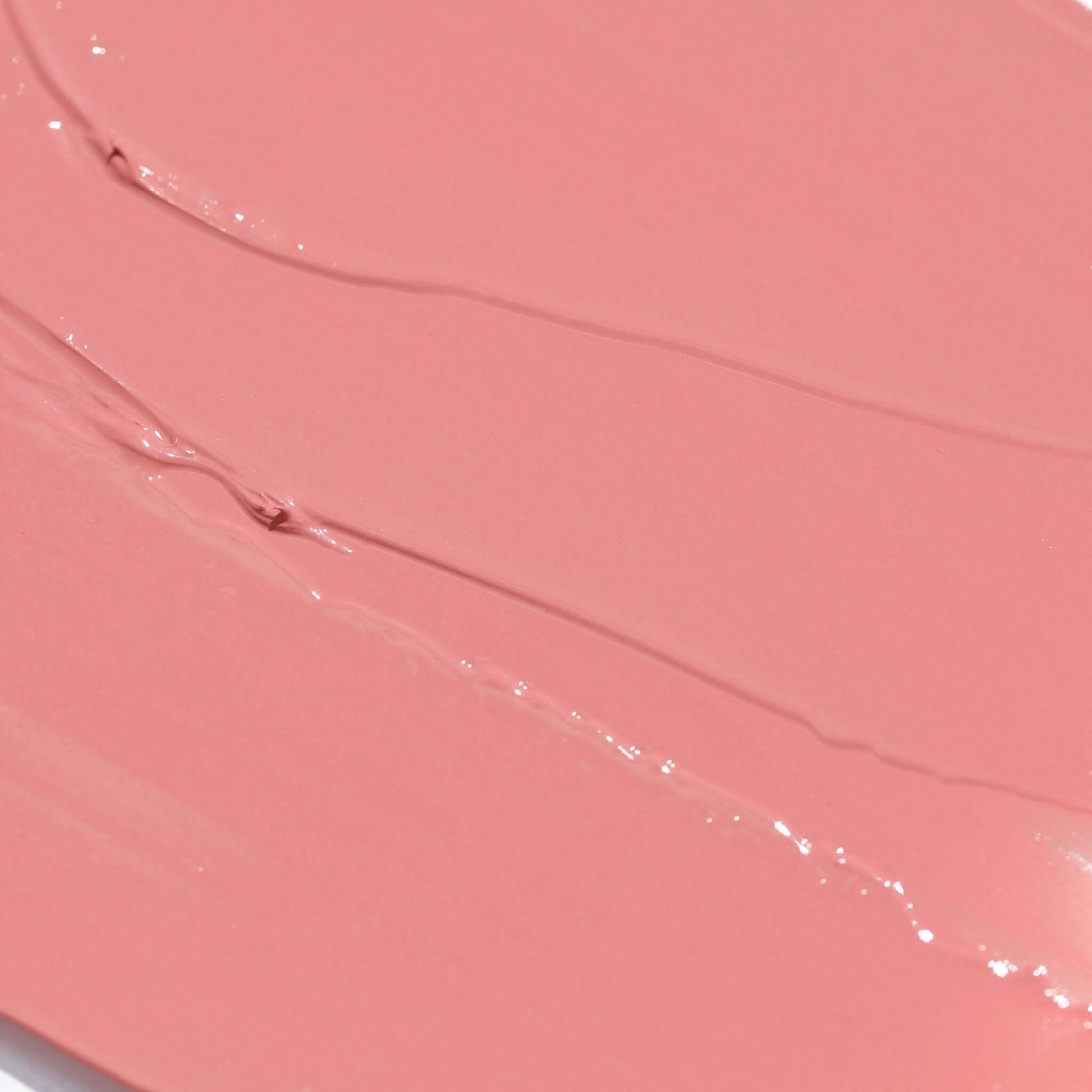 Close-up of Candy Paint Cheek + Lip Tint cream blush in a soft mauve shade with a dewy, blendable texture, perfect for a radiant skin finish.