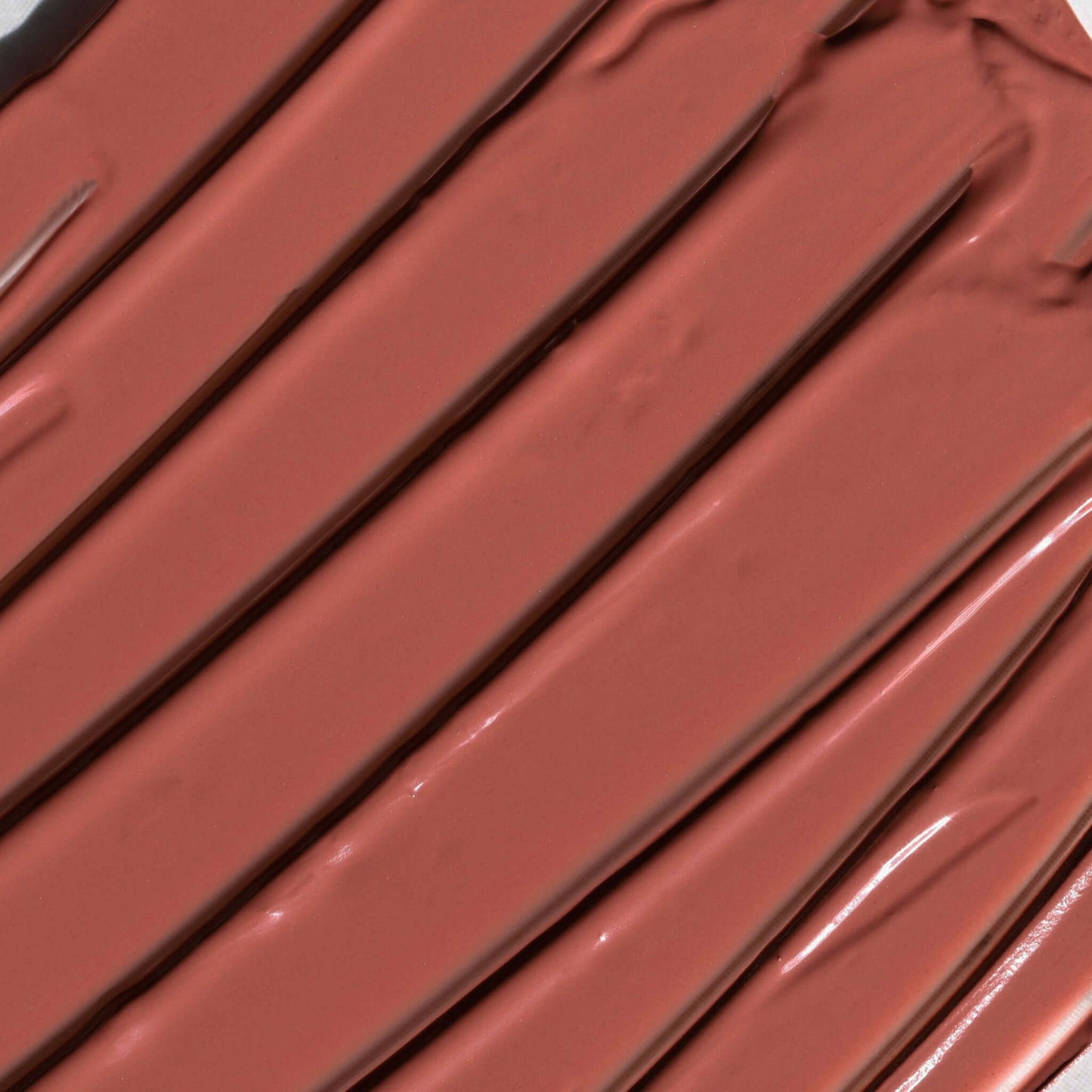 Close-up of Candy Paint Cheek + Lip Tint in shade Velvet Tiger, showcasing the creamy texture and radiant finish of the buildable cream blush.