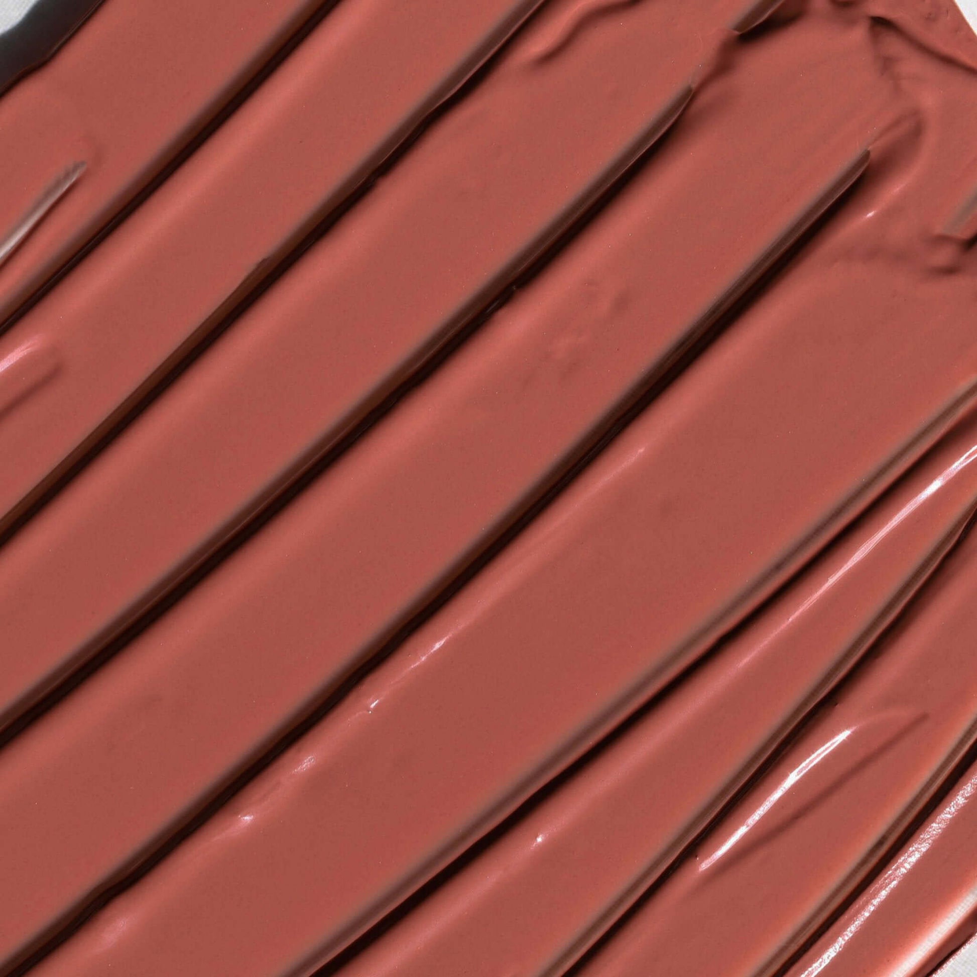 Close-up of Candy Paint Cheek + Lip Tint in shade Velvet Tiger, showcasing the creamy texture and radiant finish of the buildable cream blush.