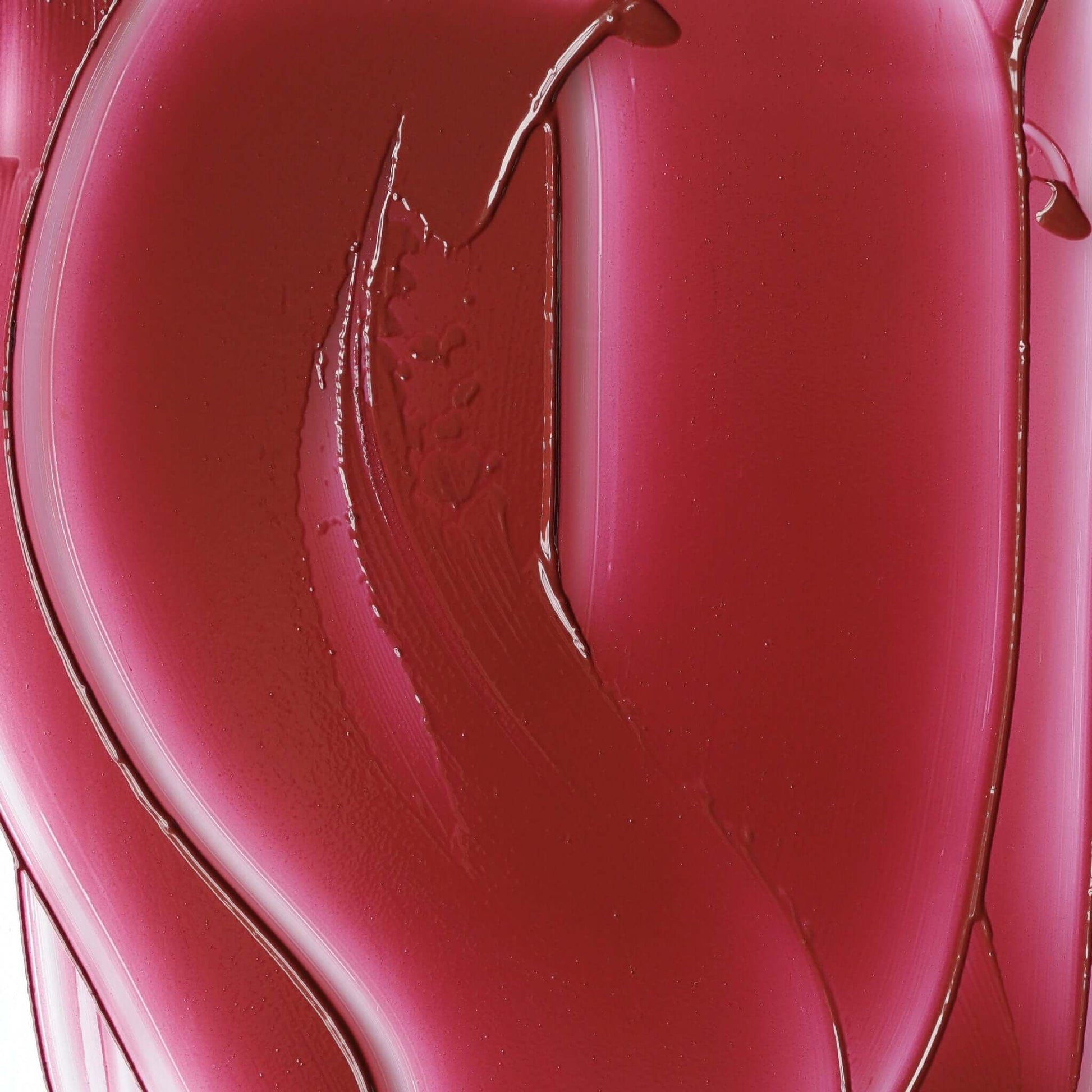 Close-up of Candy Paint Cheek + Lip Tint in a heart-shaped compact with a smooth, blendable cream texture in a vibrant shade, perfect for adding a pop of dewy, radiant color to cheeks and lips.