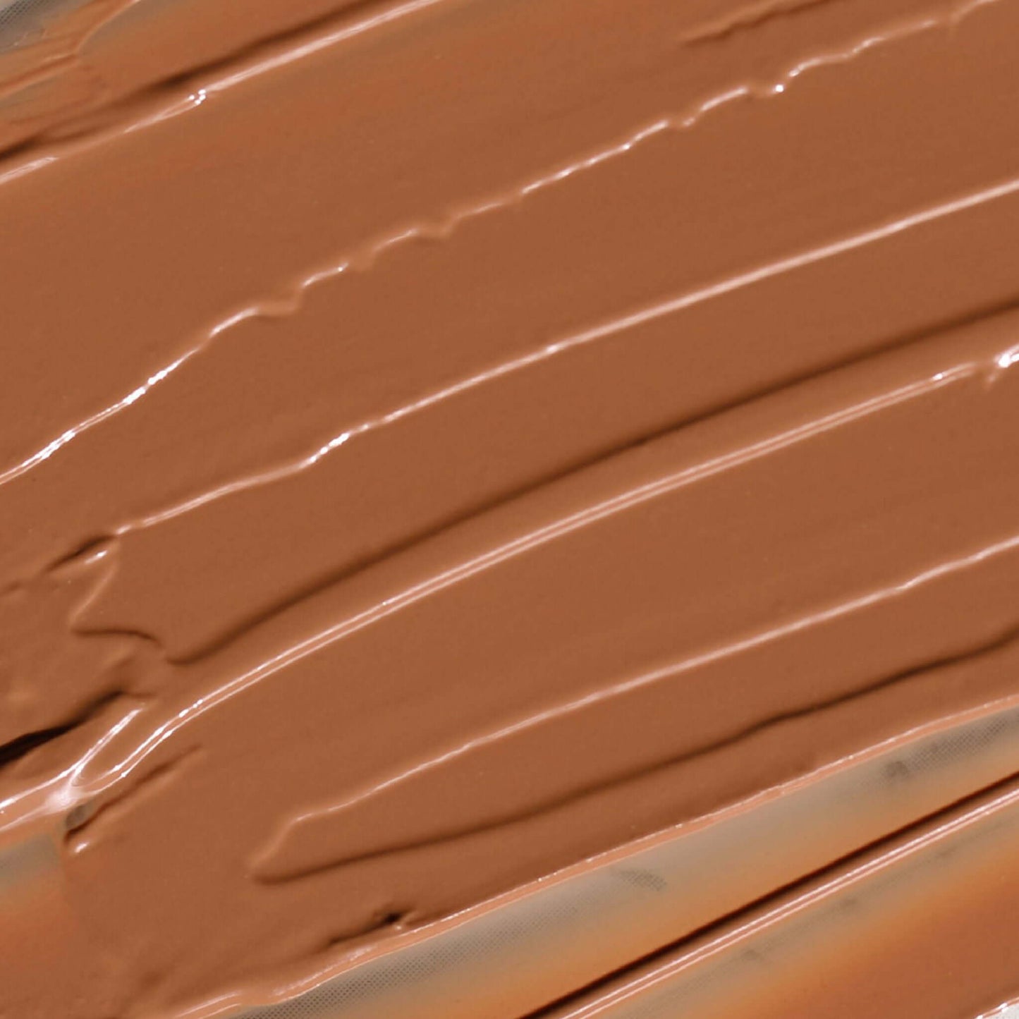 Creamy Candy Paint Cheek + Lip Tint in a warm, dewy finish, shown in a close-up swatch to highlight the product's smooth texture and blendable nature.