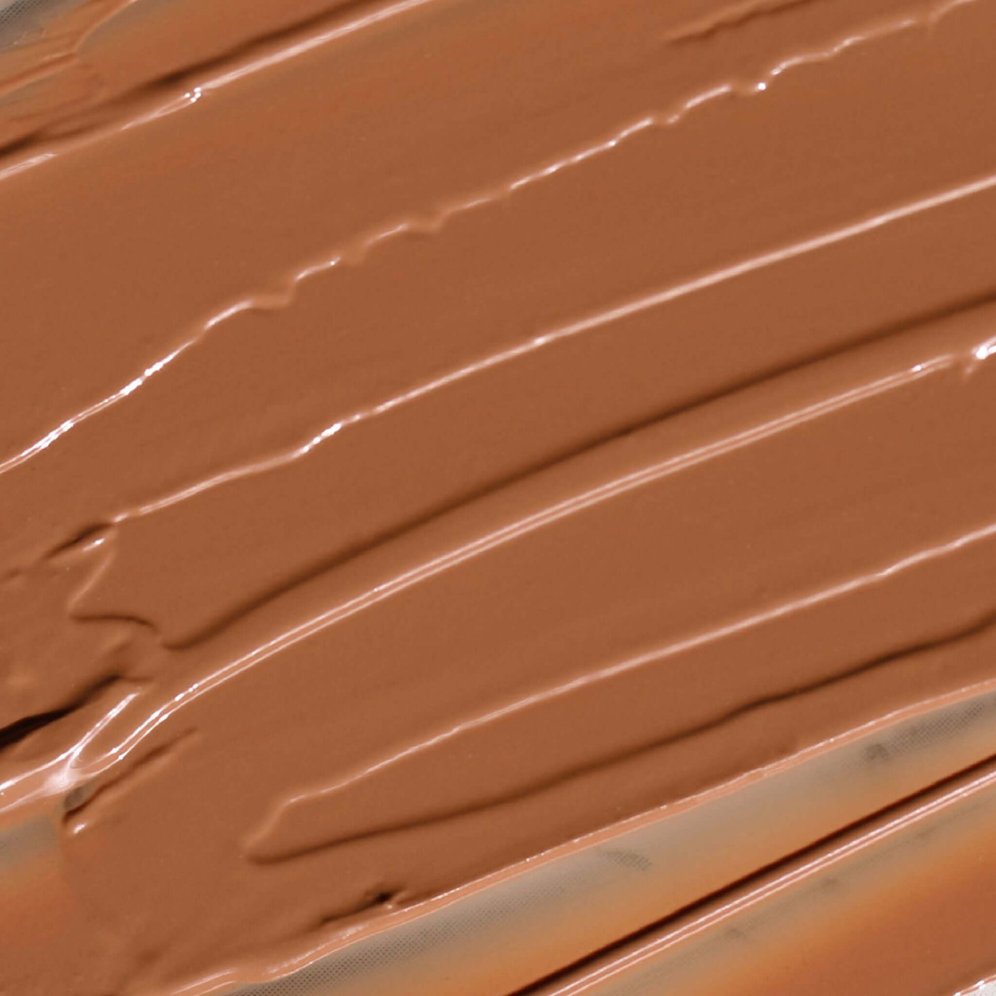 Creamy Candy Paint Cheek + Lip Tint in a warm, dewy finish, shown in a close-up swatch to highlight the product's smooth texture and blendable nature.